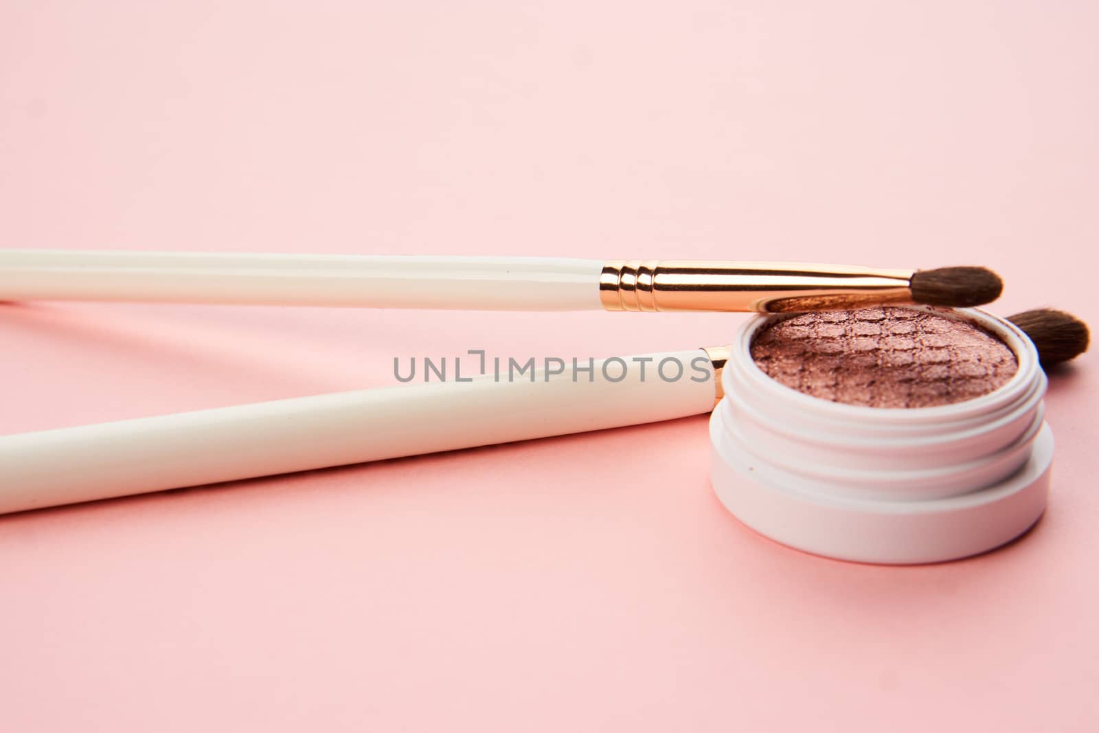 makeup brushes and eyeshadow professional cosmetics on pink background. High quality photo