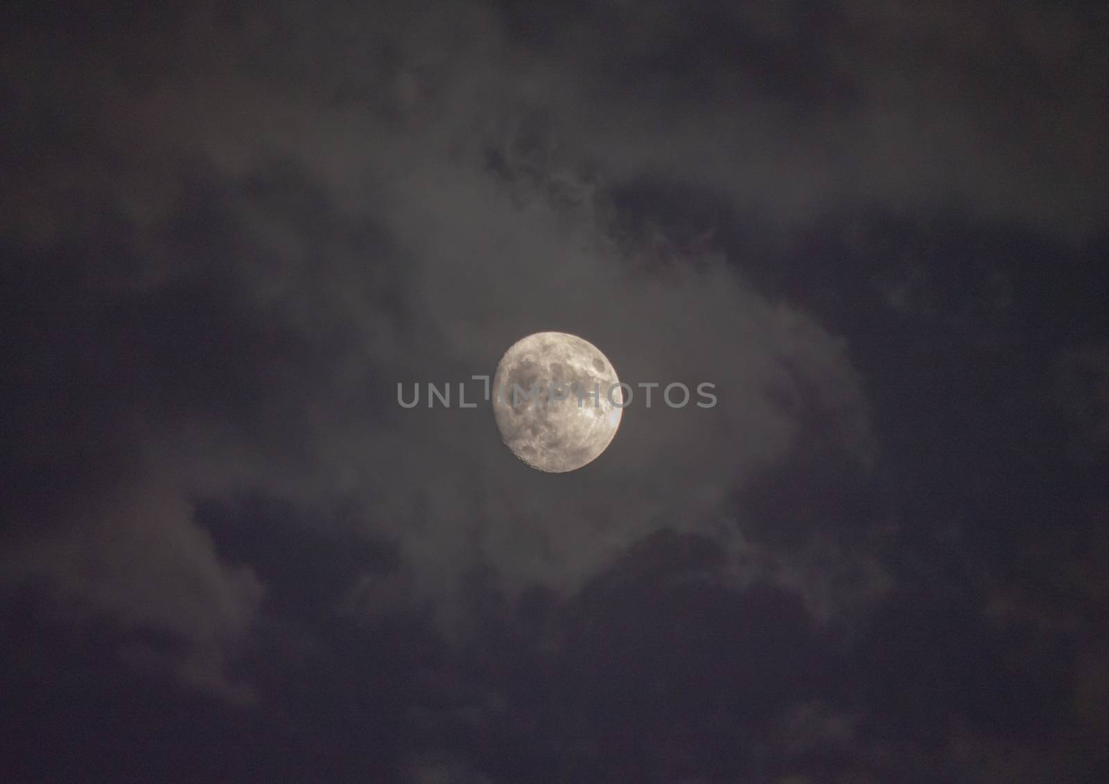 Full moon in night mystic sky with clouds