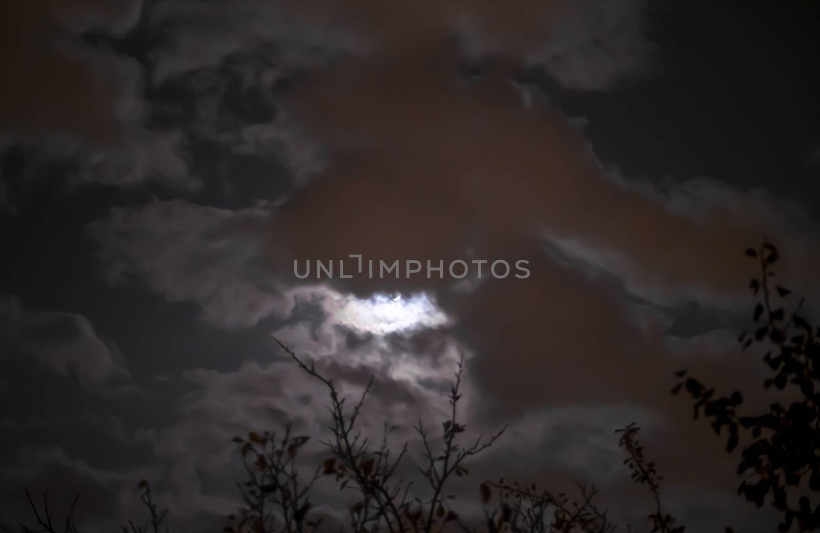 Full moon in night mystic sky with clouds