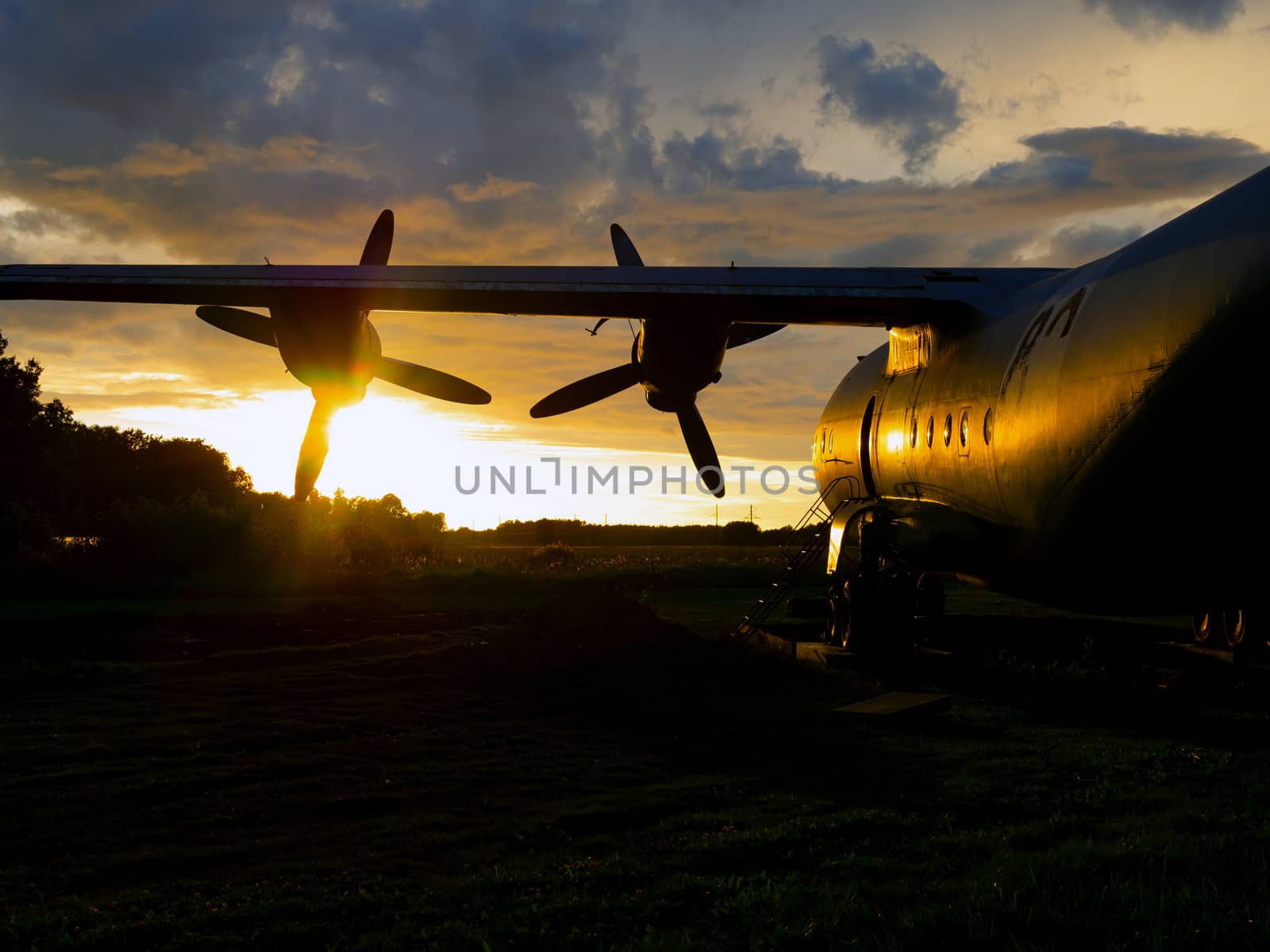 old Soviet military airplane, sunset time. Abandoned Historic Aircraft in Estonia AN-12. Close up of propeller engine. Copy space
