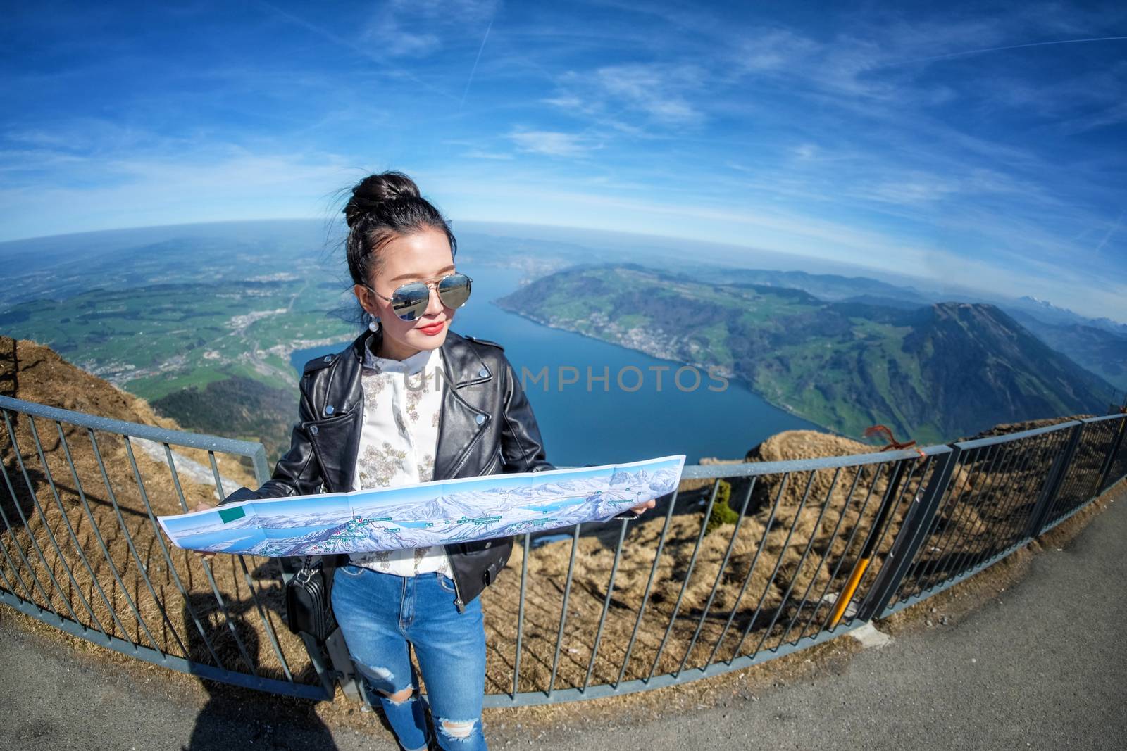 Young female tourist looking map at Rigi mountain in Switzerland by Surasak