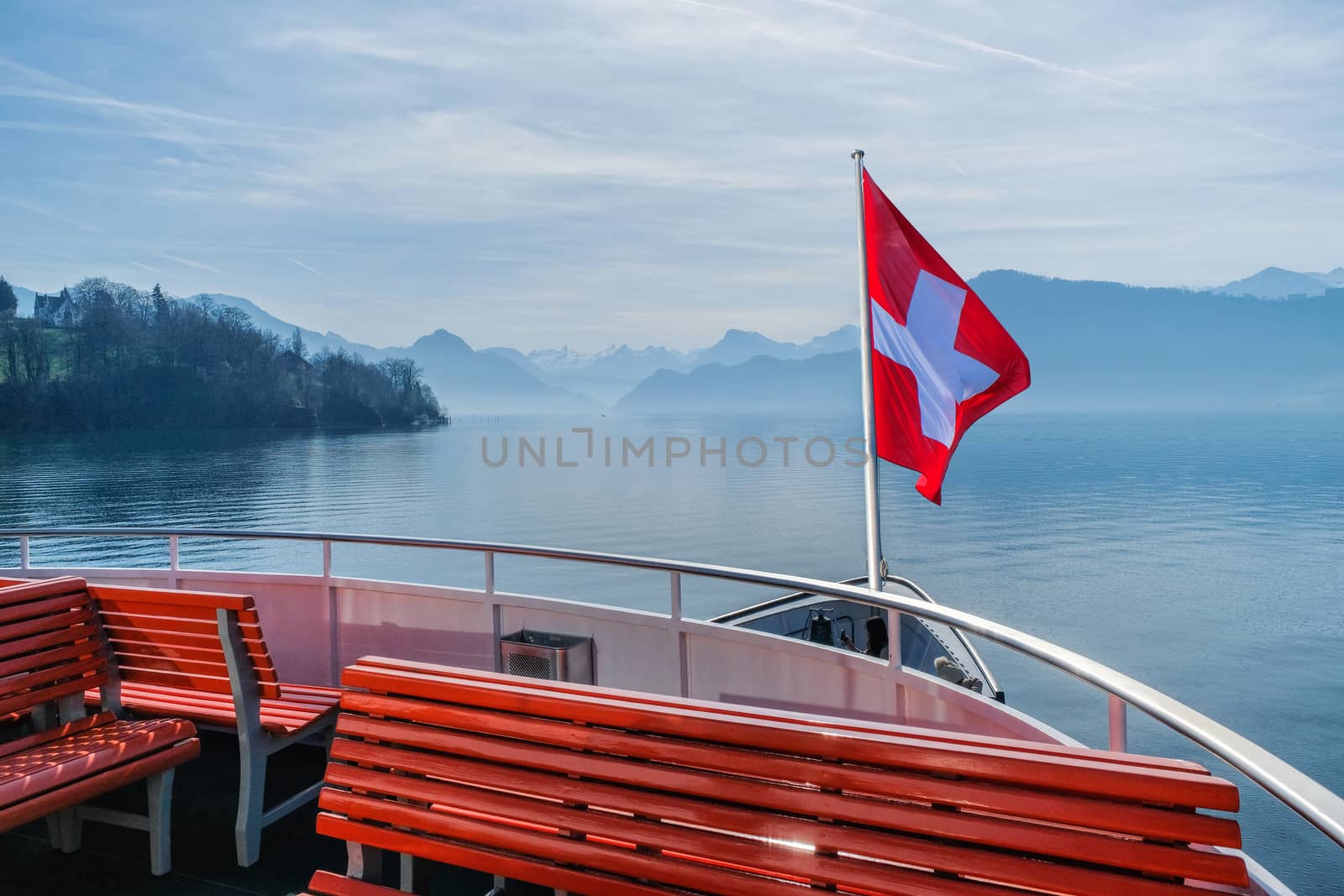 Swiss flag flying on boat and Rigi mountain view background