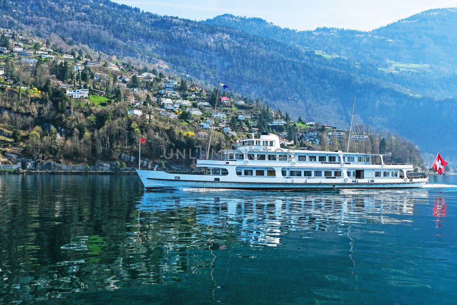 Tourist ferry boat taking passengers across the majestic and beautiful Lake Lucerne in Switzerland.