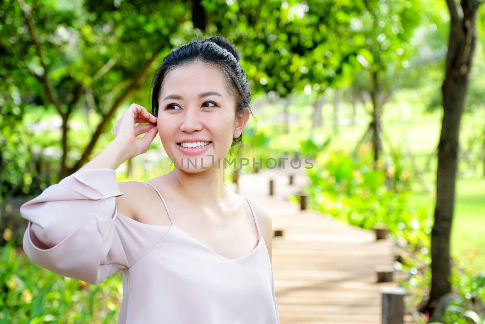 Portrait young woman smiling in the nature by Surasak