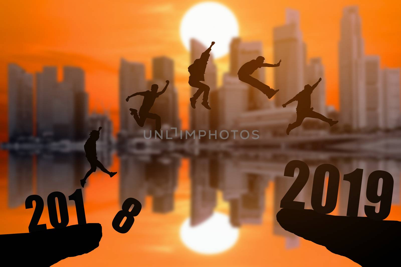 Silhouette group of young mans jumping between 2018 and 2019 years with beautiful sunset at the skyscrapers background, concepts of news year and business target.