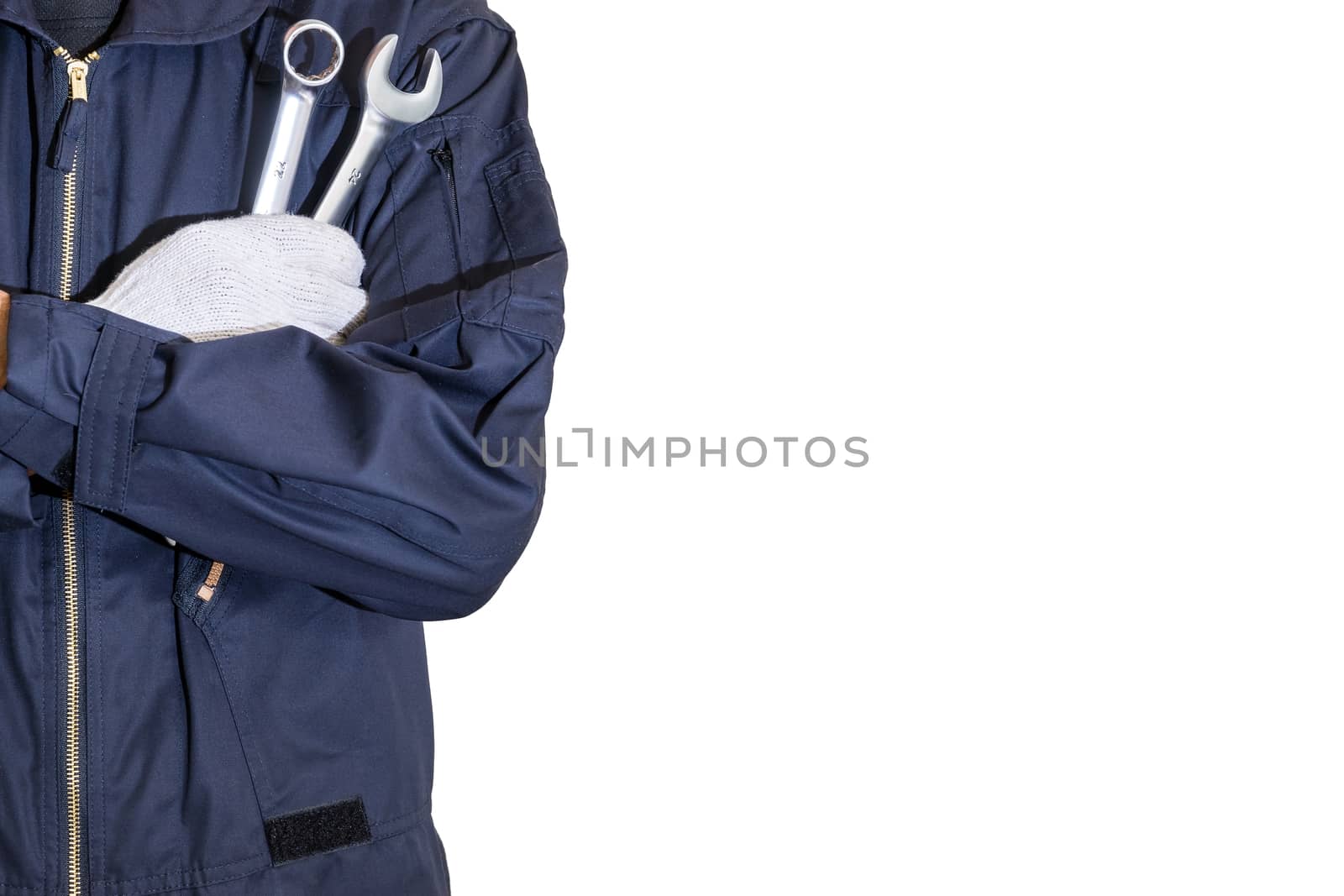 Car repairman wearing a dark blue uniform standing and holding a wrench that is an essential tool for a mechanic isolated on white background, Automotive industry and garage concepts.