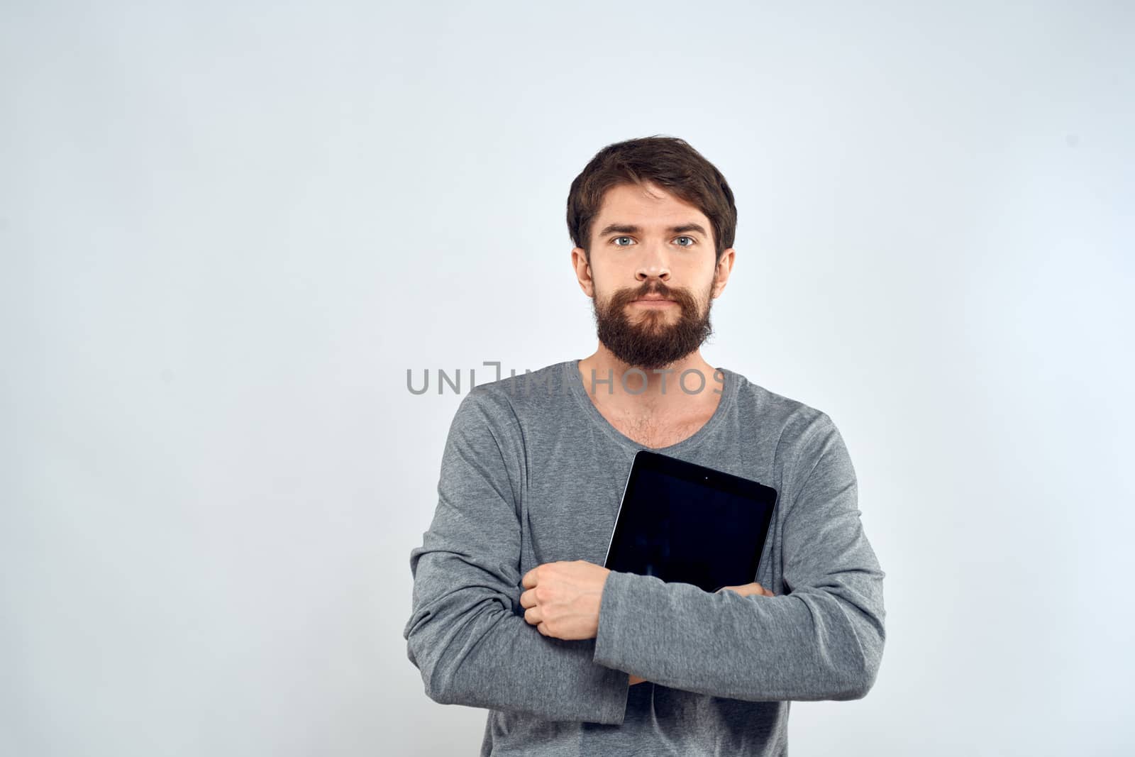 emotional man holding tablet technology communication internet work light background by SHOTPRIME