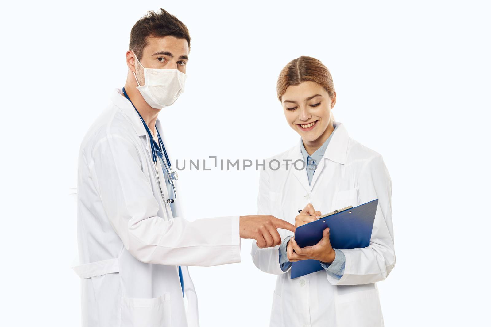 doctor and nurse in medical mask with documents in hand and gown isolated background