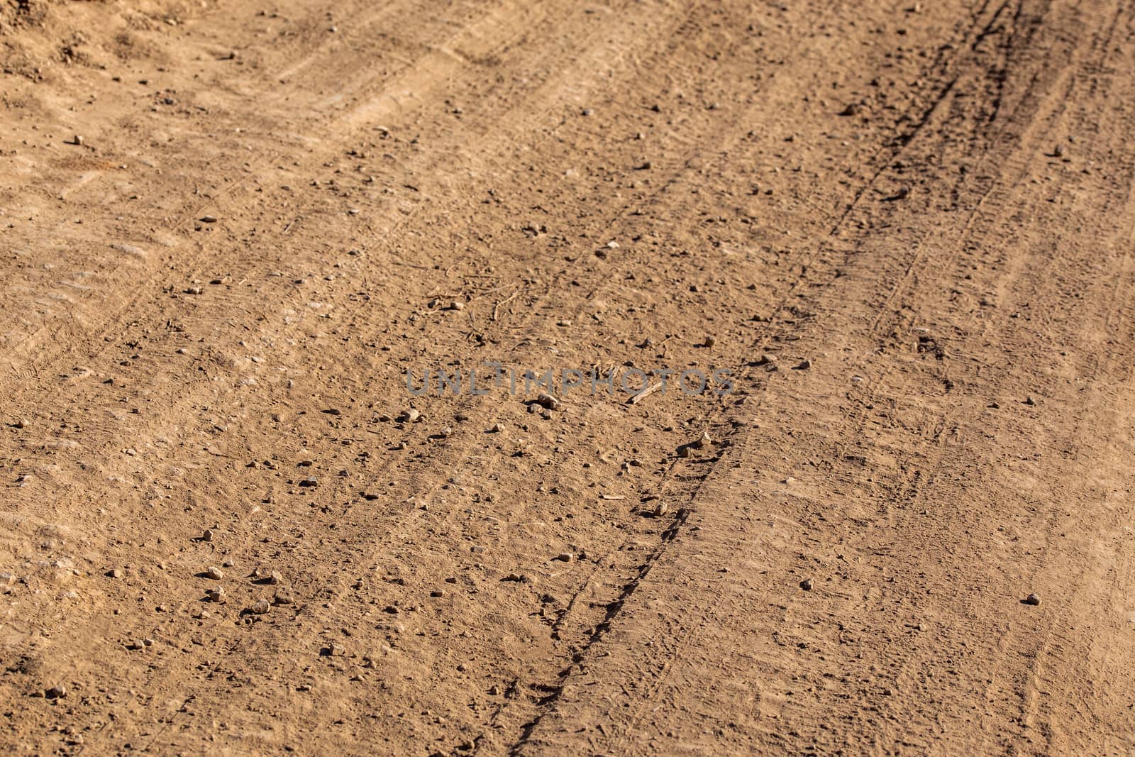 dusty dry dirt road under direct sun light - full frame close-up shot