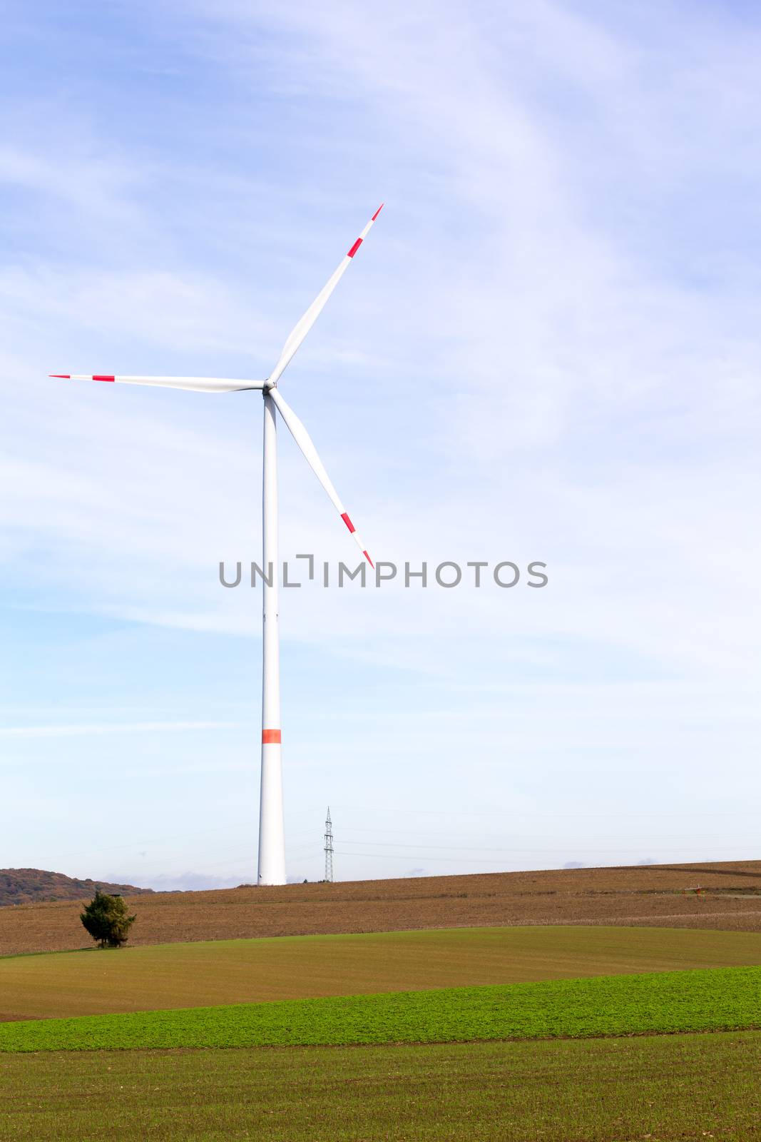 The windmill on a field with blue sky