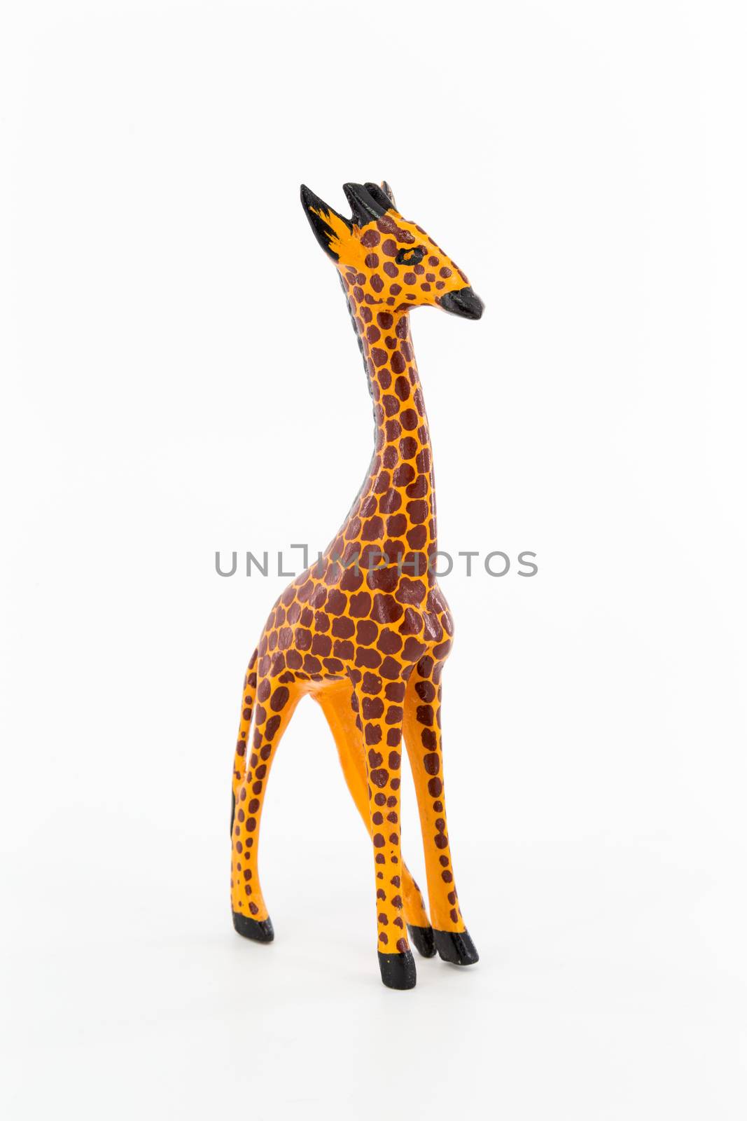 A wooden figure of a giraffe on white background