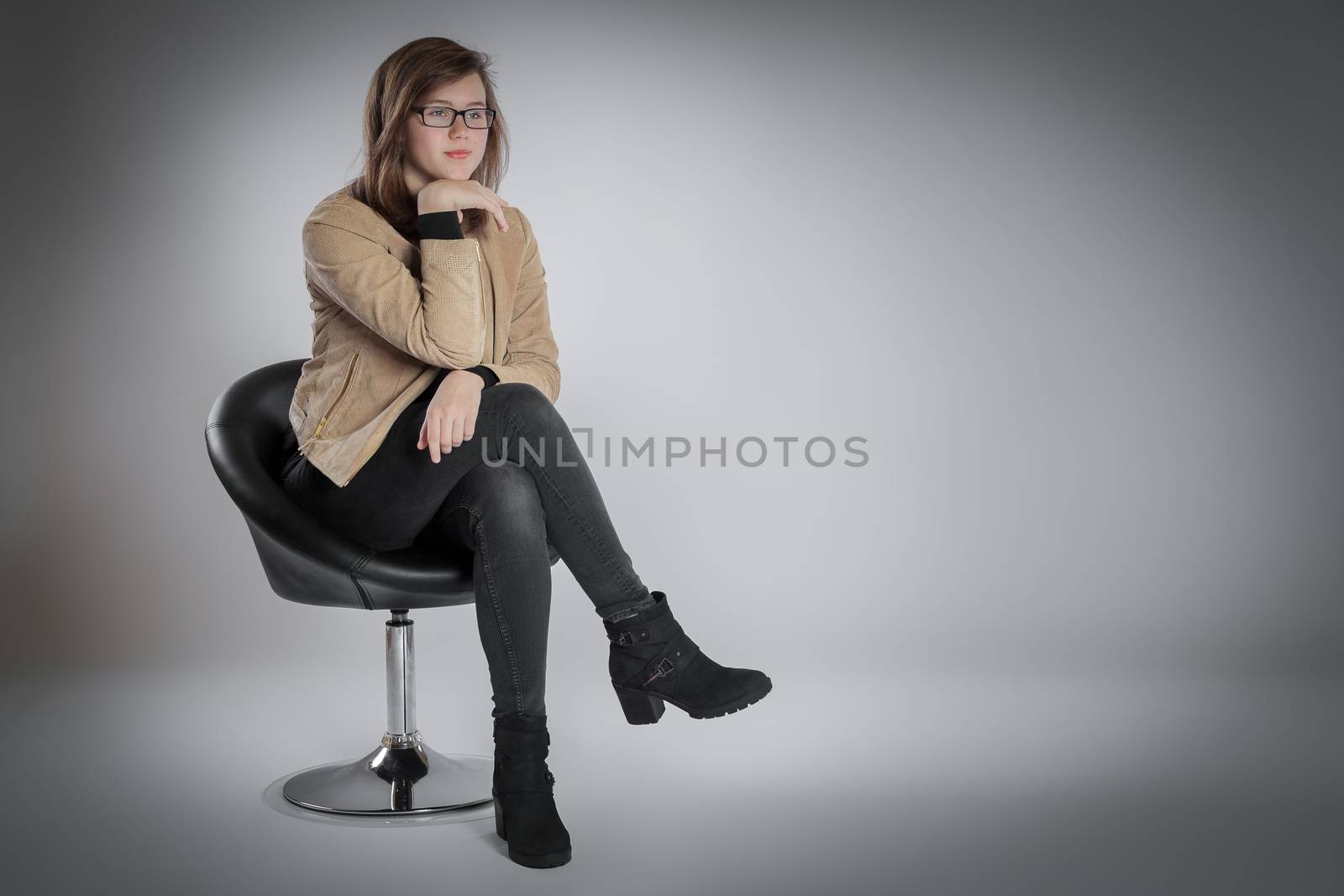 Young woman is sitting on a chair