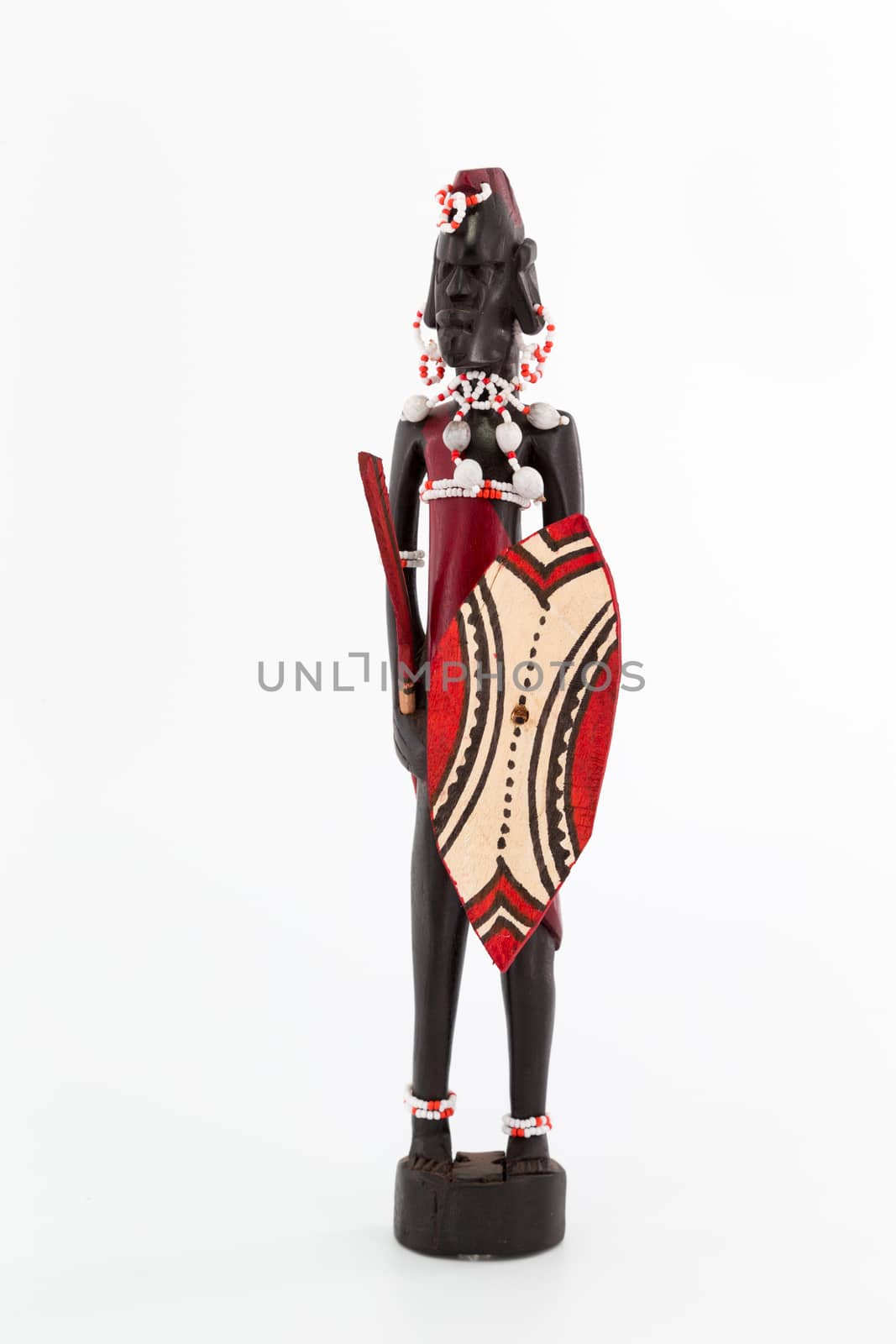 A wooden figure of a Maasai man on white background