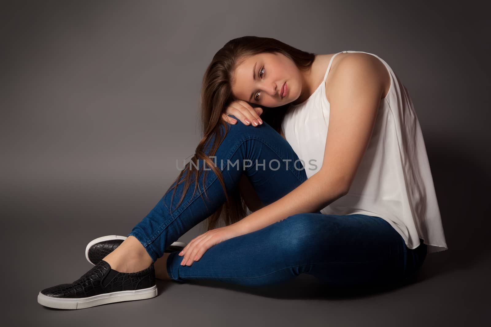 Young woman is sitting on floor