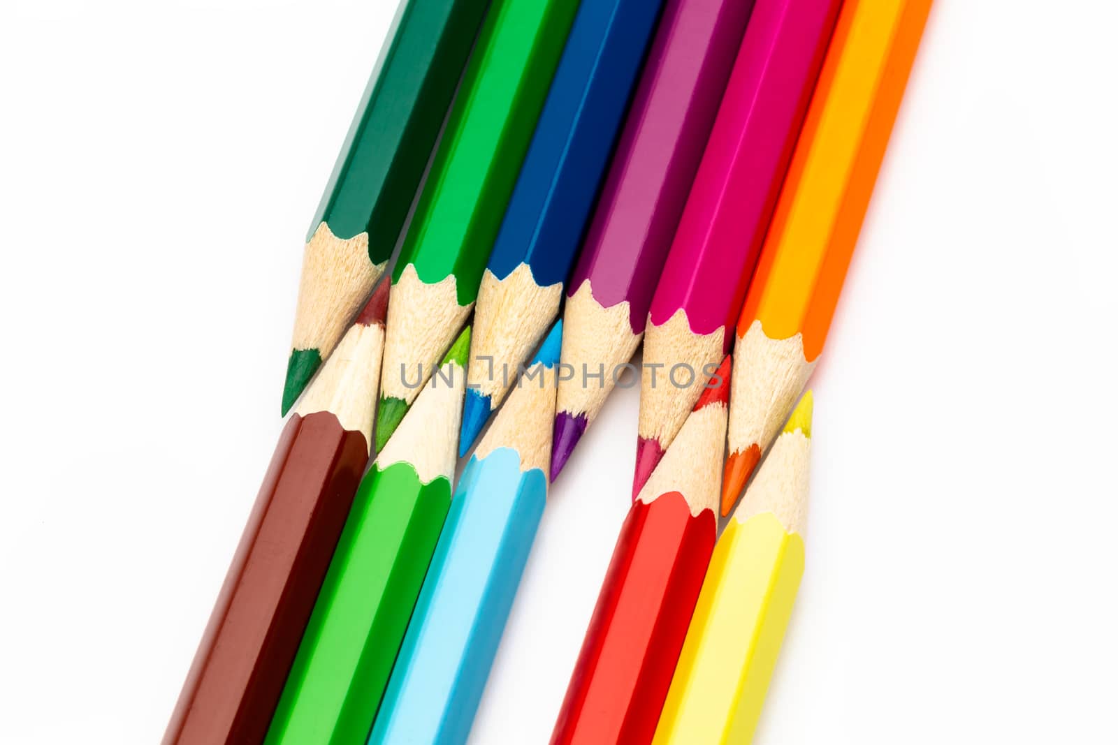 A wooden colored pencils of different colors on a white background