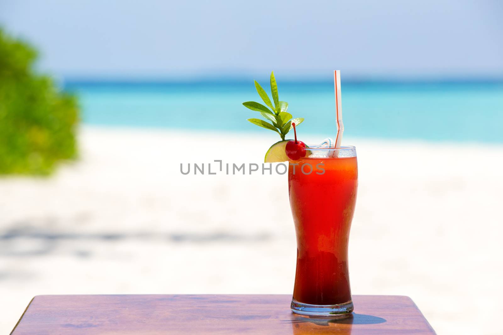 One colorful cocktail on the beach of an island