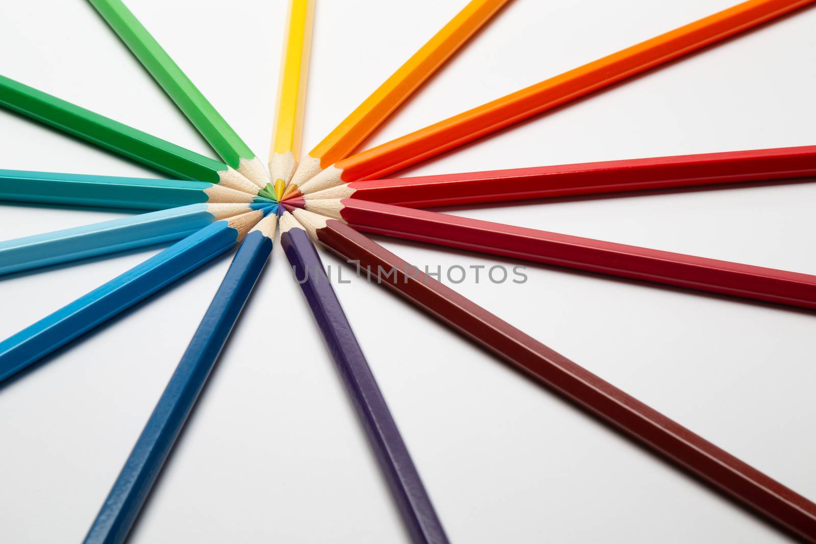 Some colorful wooden pencils on a white background