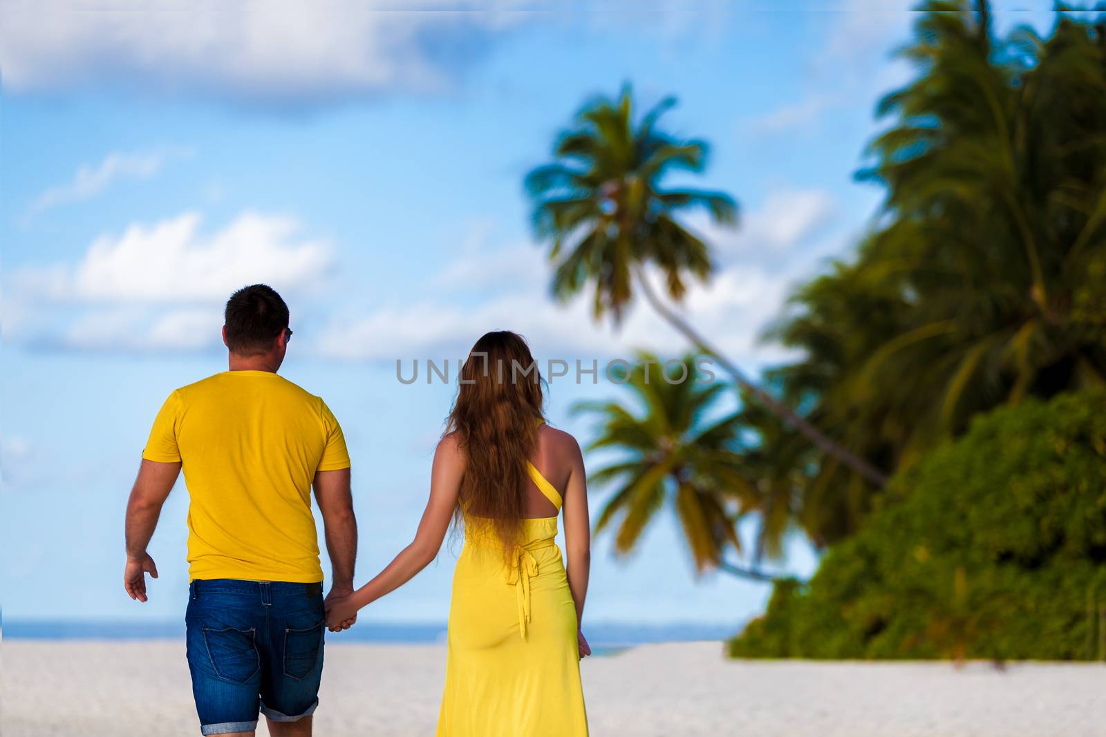 Maldives, a couple walking along the beach by 25ehaag6