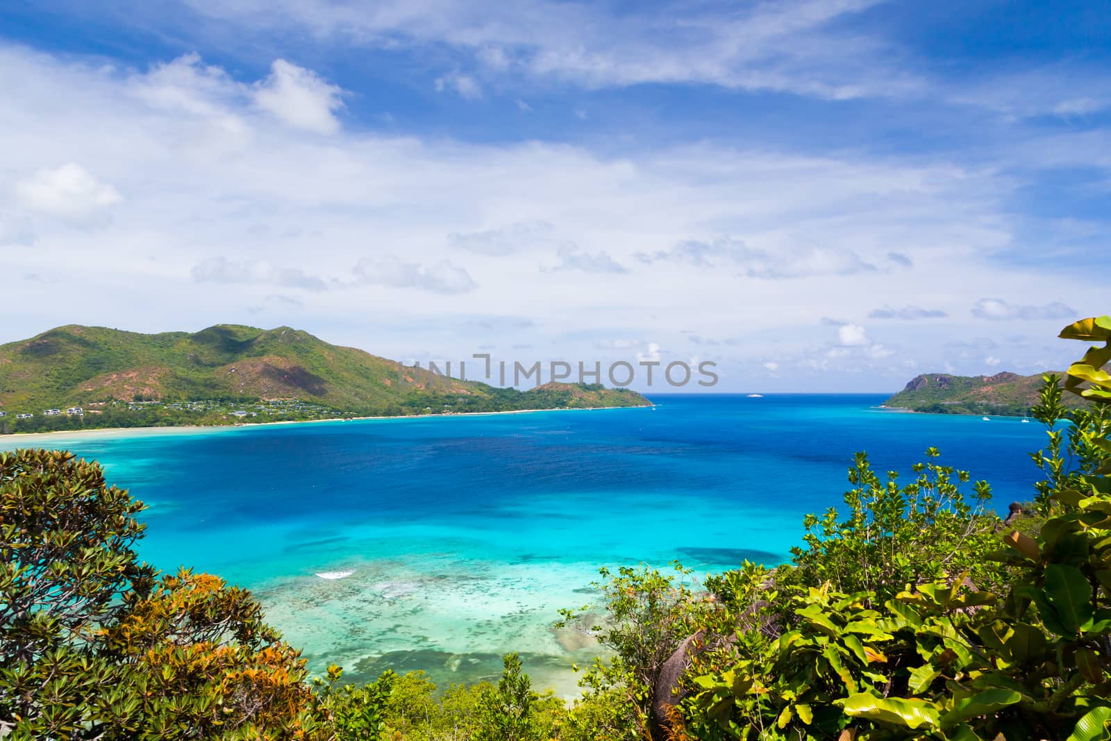 View from the main island to an another island in the near with a lot of plants and blue sky