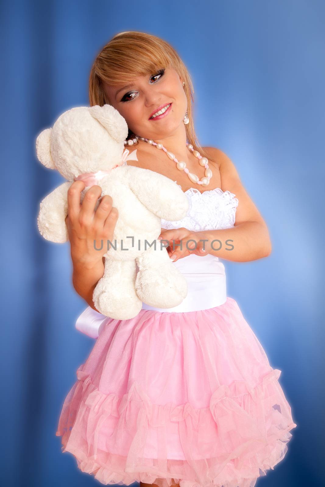 young blonde girl with a soft toy