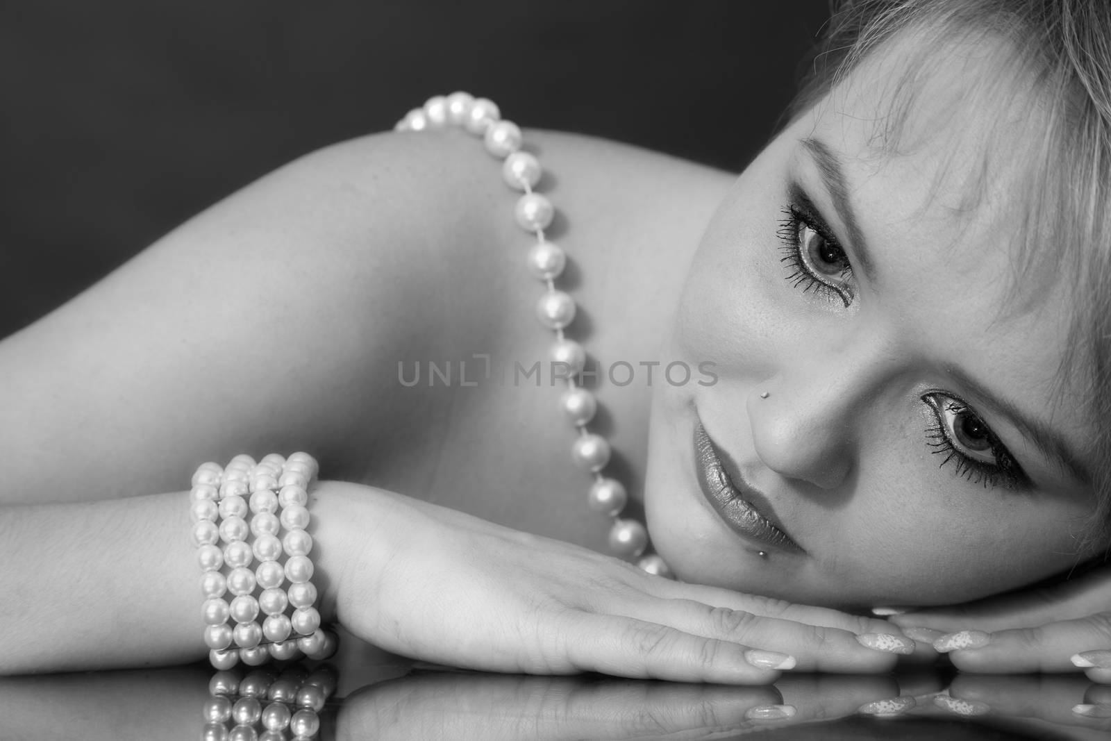 the face of a young attractive woman with pearl necklace by 25ehaag6