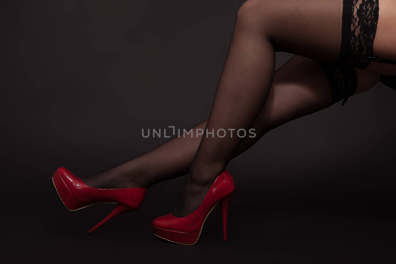 Legs of a woman in stockings and high heels