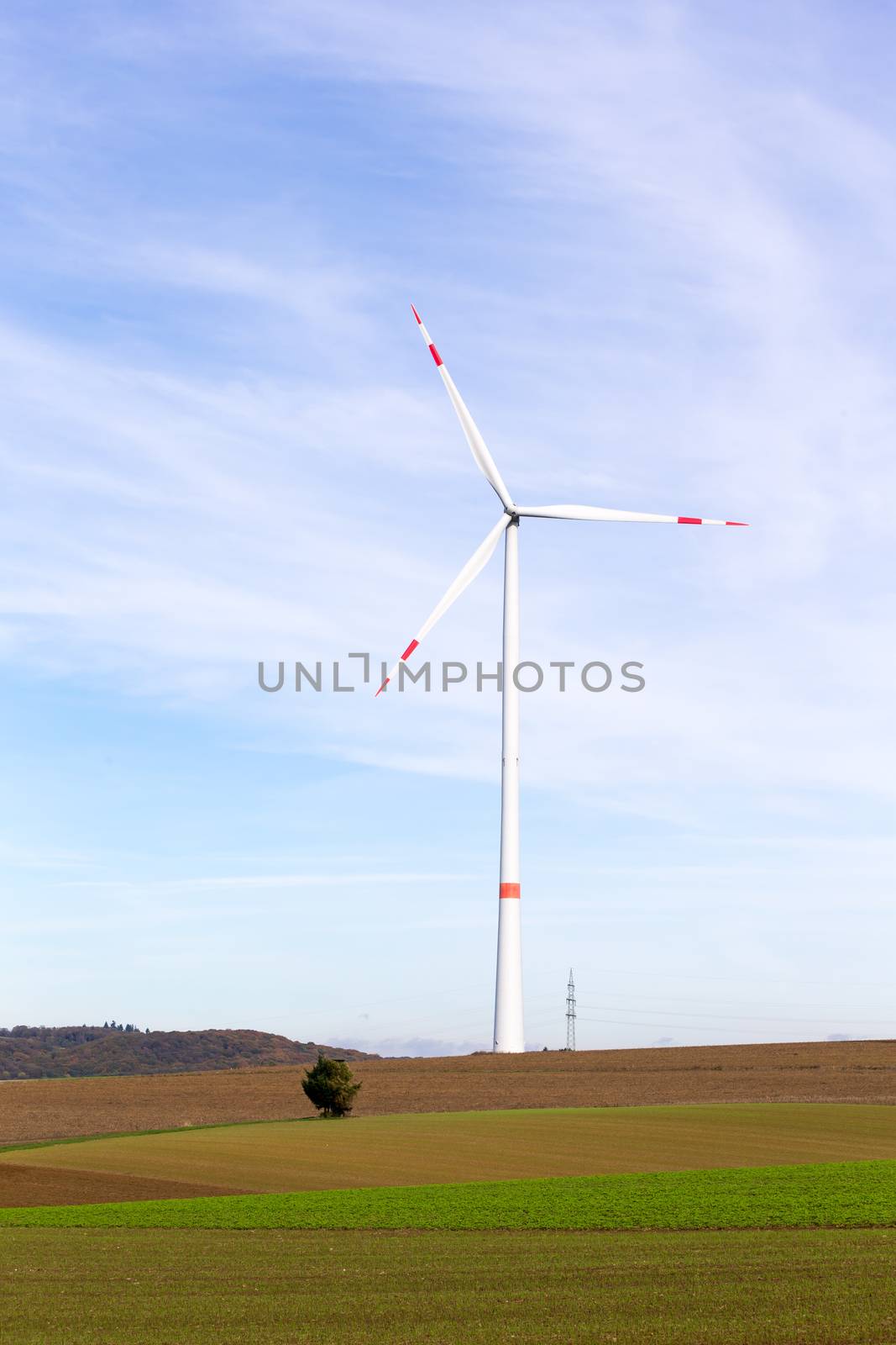 The windmill on a field with blue sky