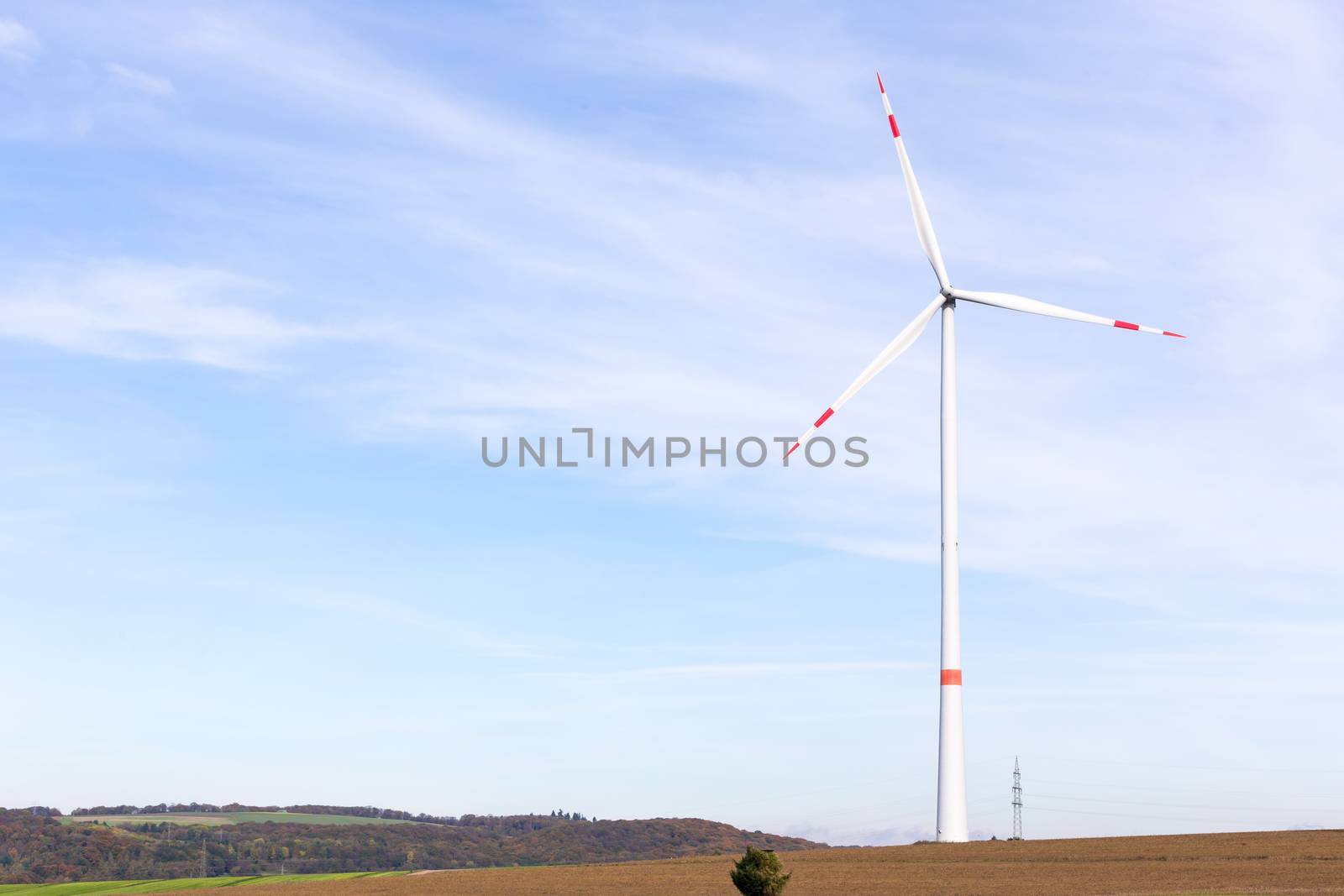 The windmill on a field with blue sky