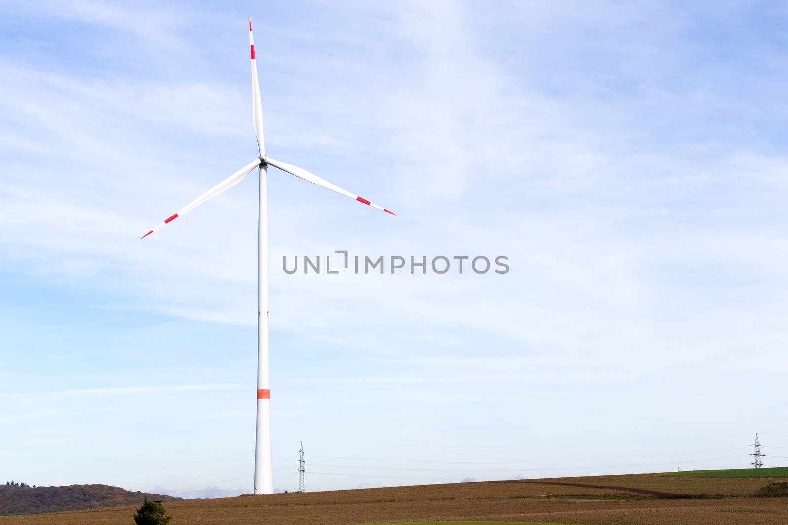 The windmill on a field with blue sky