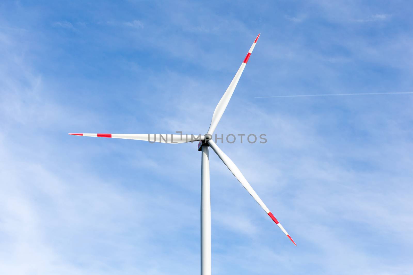 The windmill with a blue sky in the background
