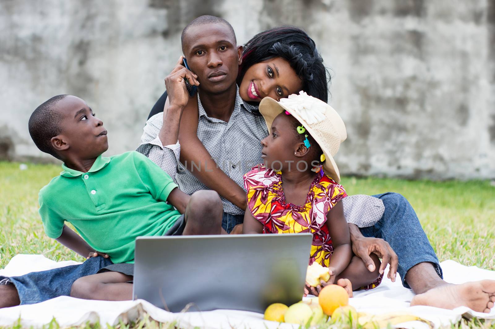 happy family playing together at the park during their holidays