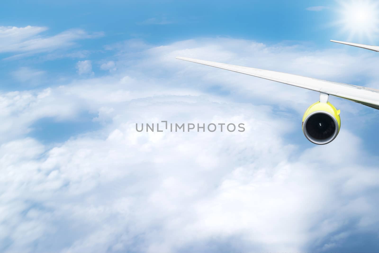 Closeup to the wing of the airplane that was flying in the sky. by wattanaphob