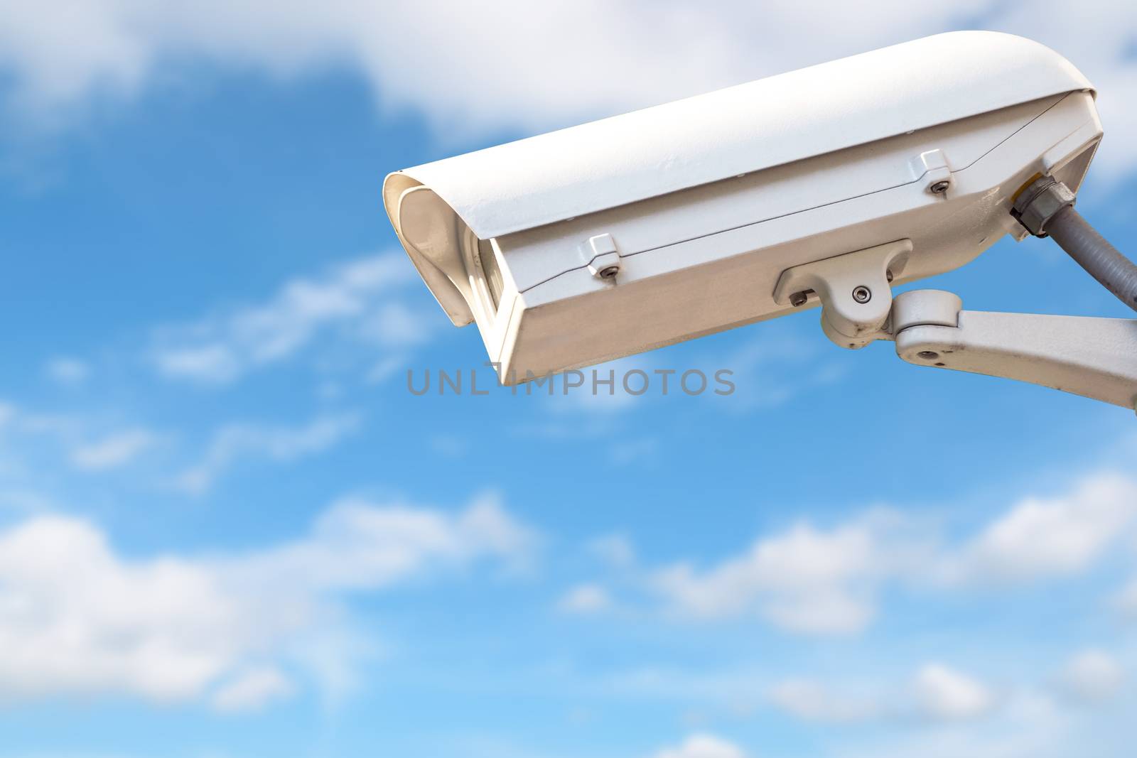 CCTV or surveillance camera  recording  important events and a guard house and property against blue sky.