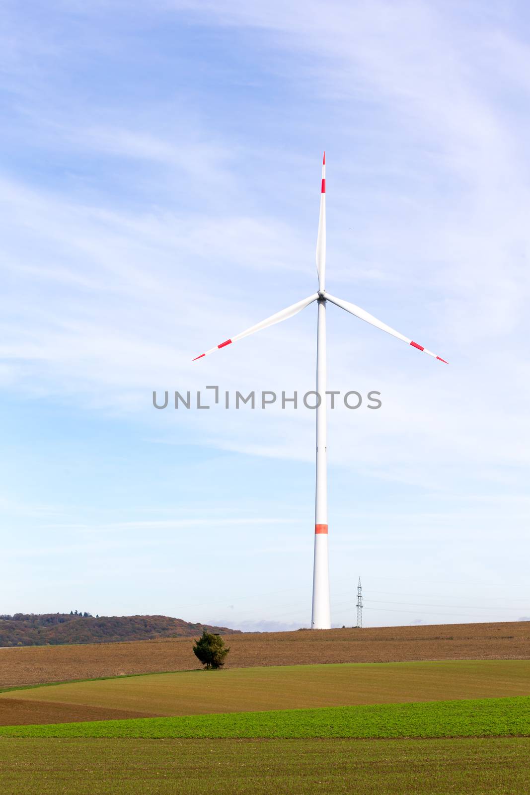 The windmill on a field with blue sky