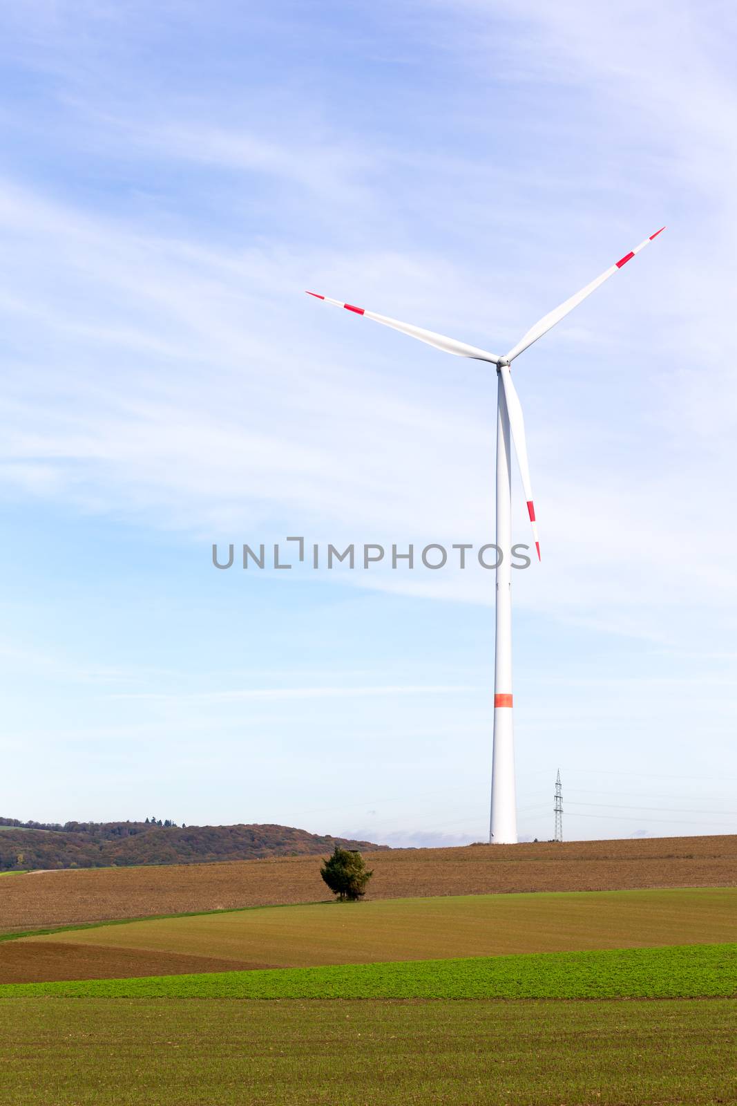 The windmill on a field with blue sky