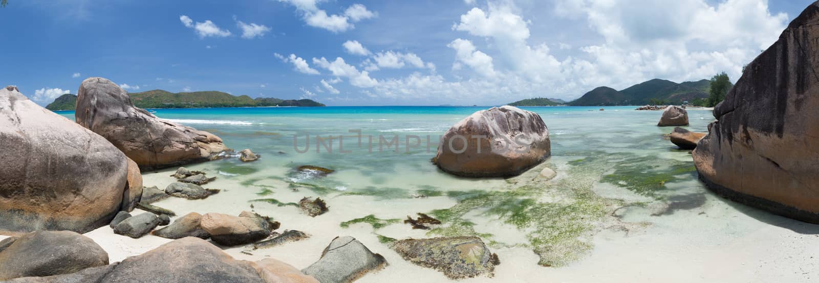 Big stones on the beach of the Seychelles and clear water