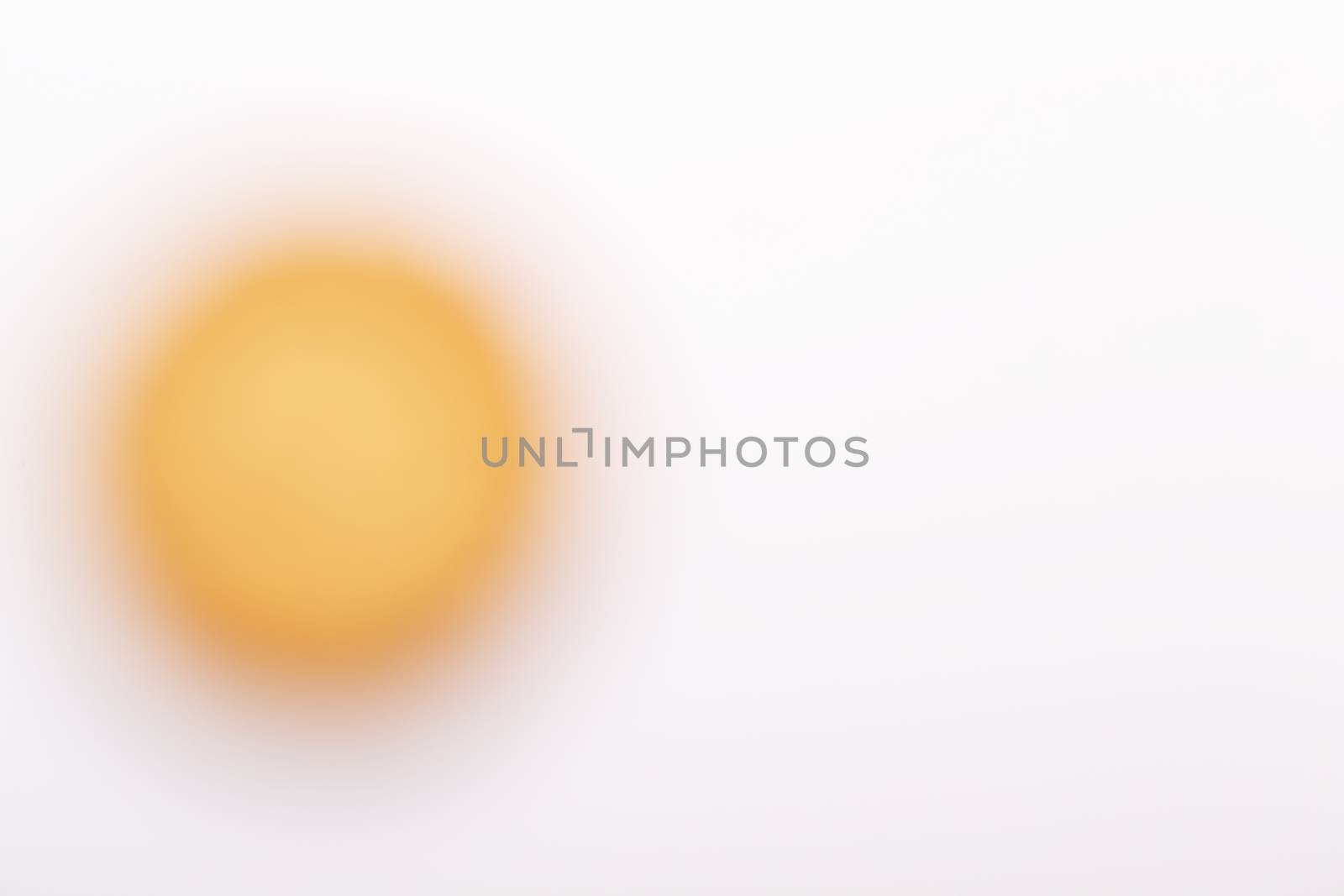 A Yellow blurred circle on a white background