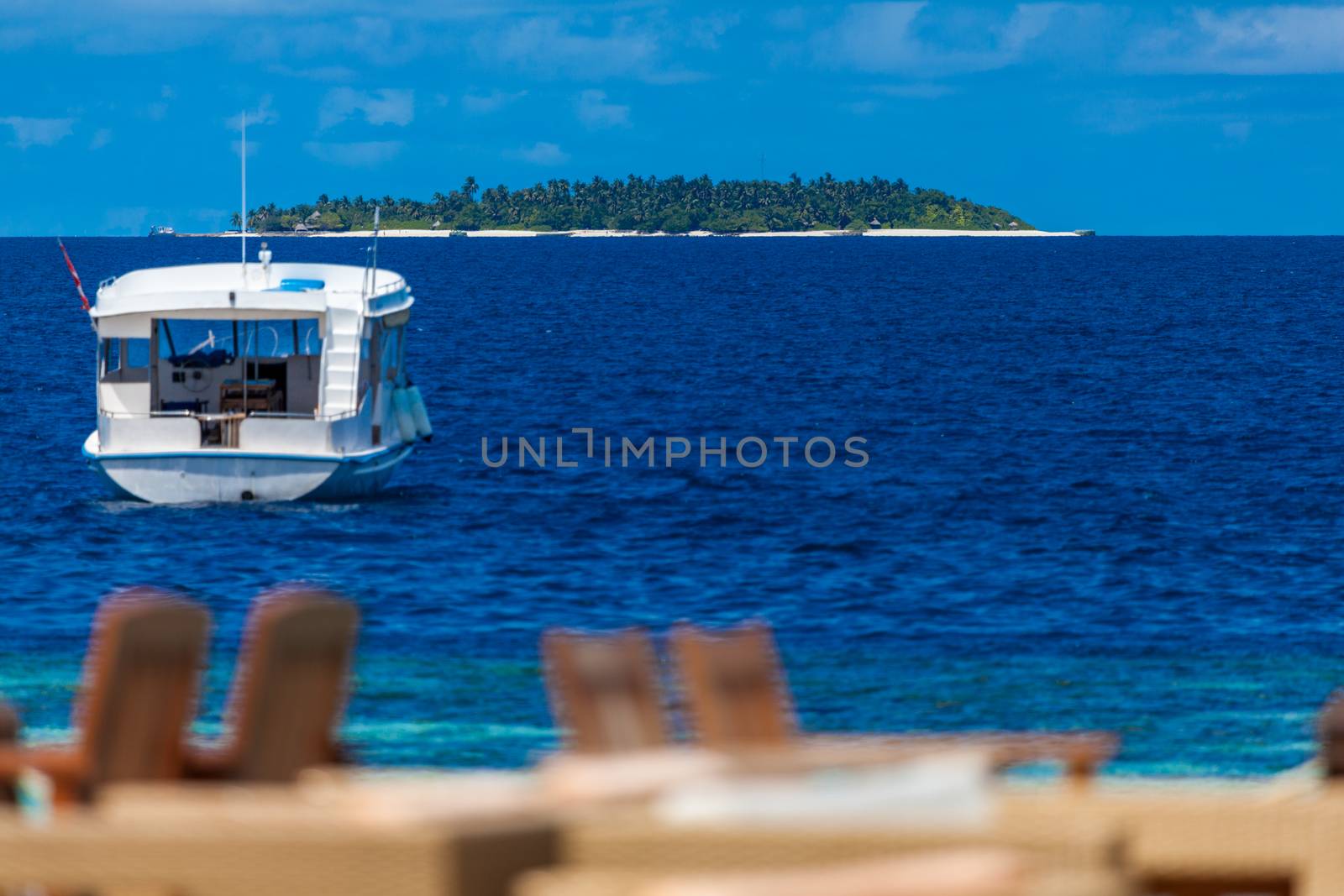 View from the beach bar to the ocean with a boat and an another island