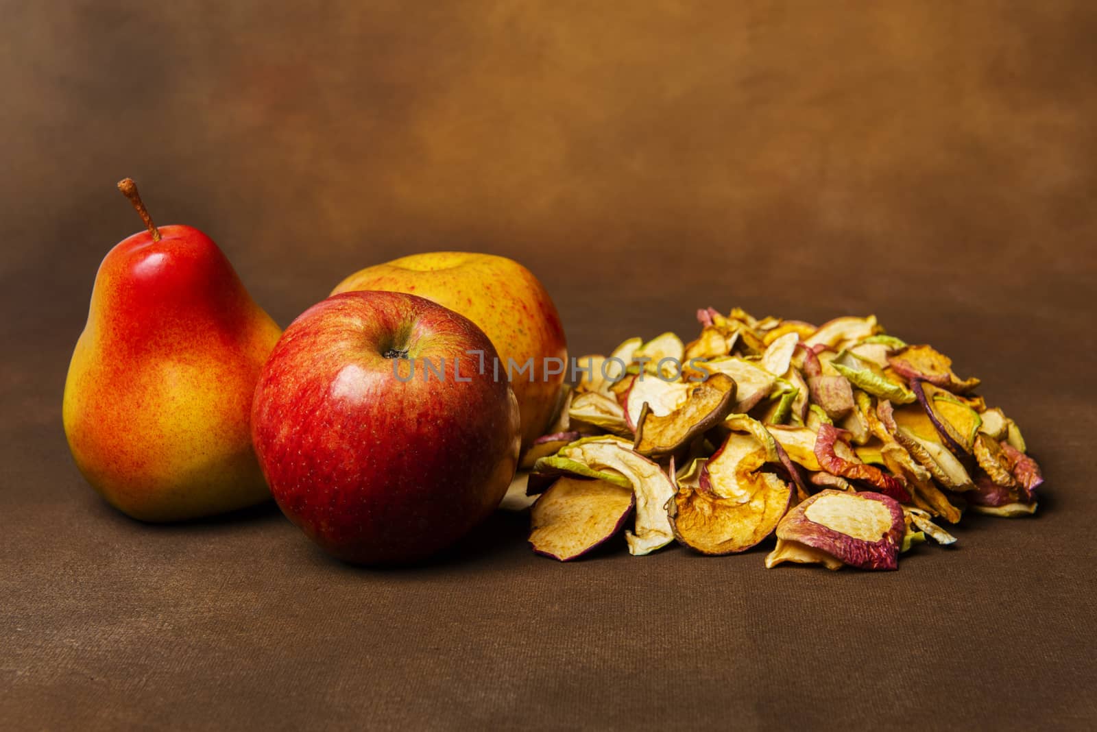 Dried apples and pears on a brown background by fyletto