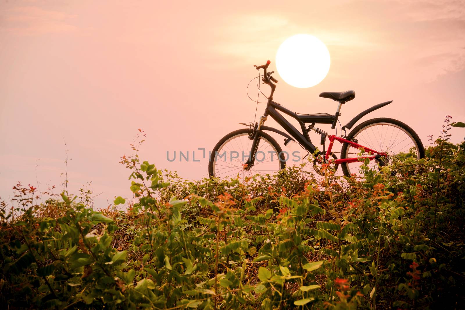 Closeup of the mountain bike with a colorful sky and sunset, vintage tone filter for poster or postcard.