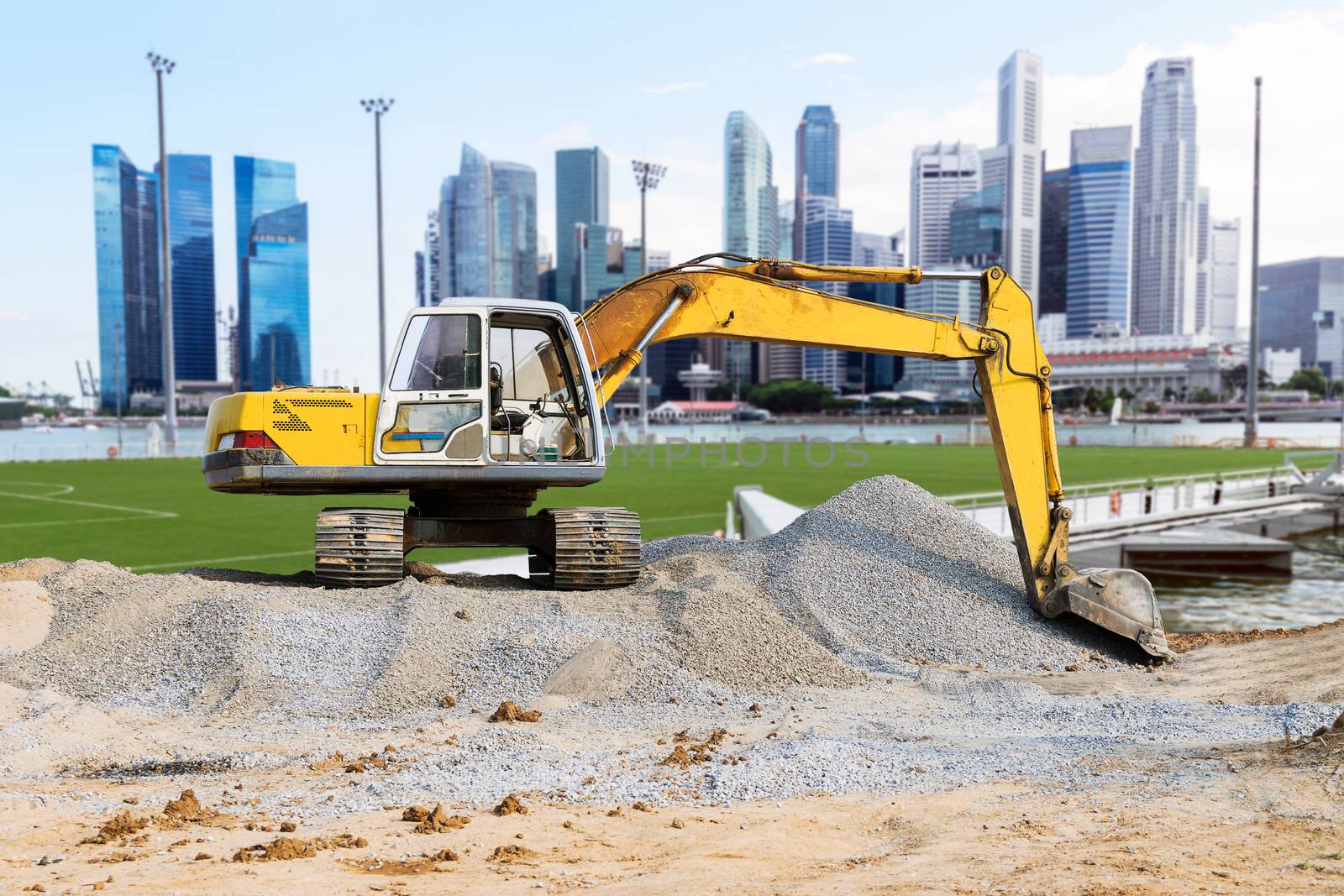 Excavator parked on the mound. by wattanaphob