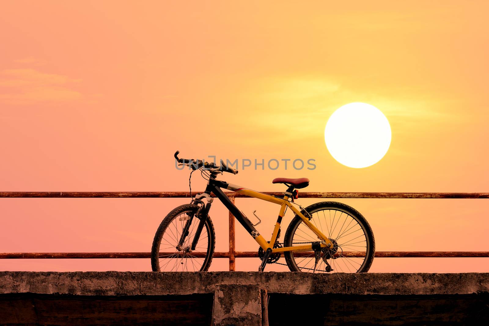 Beautiful mountain bike on concrete bridge  with colorful sunlight ; vintage filter style for greeting card and post card.