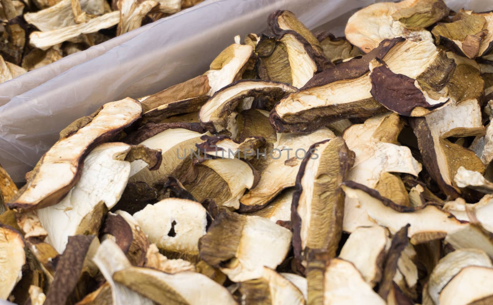 A counter with thinly sliced dried forest mushrooms. Farmer's market