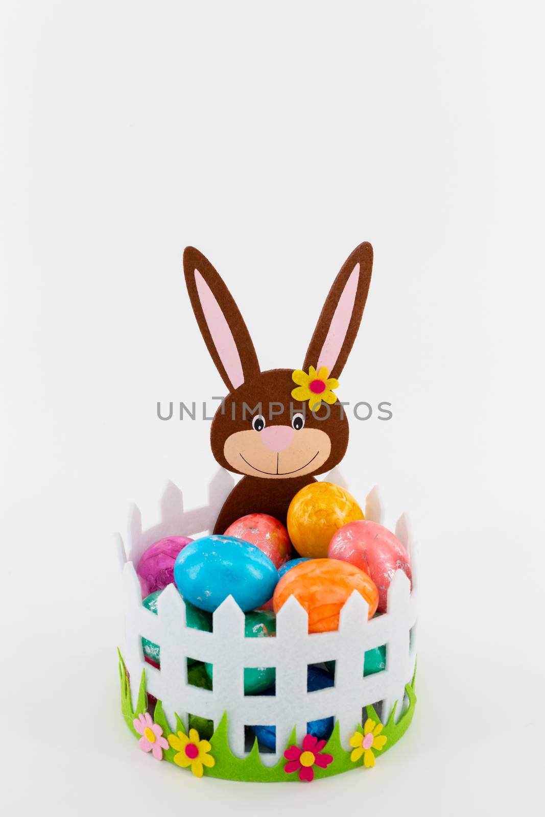 Some Colorful Easter eggs in a basket with an Easter bunny