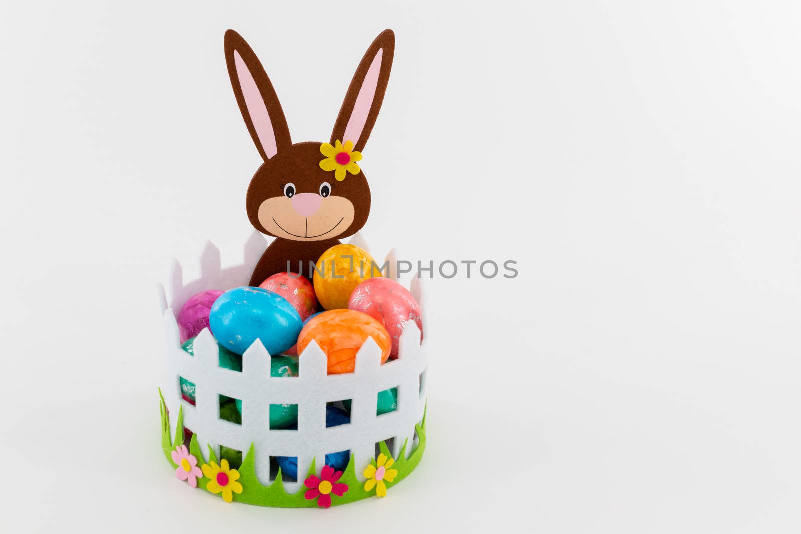 Some Colorful Easter eggs in a basket with an Easter bunny
