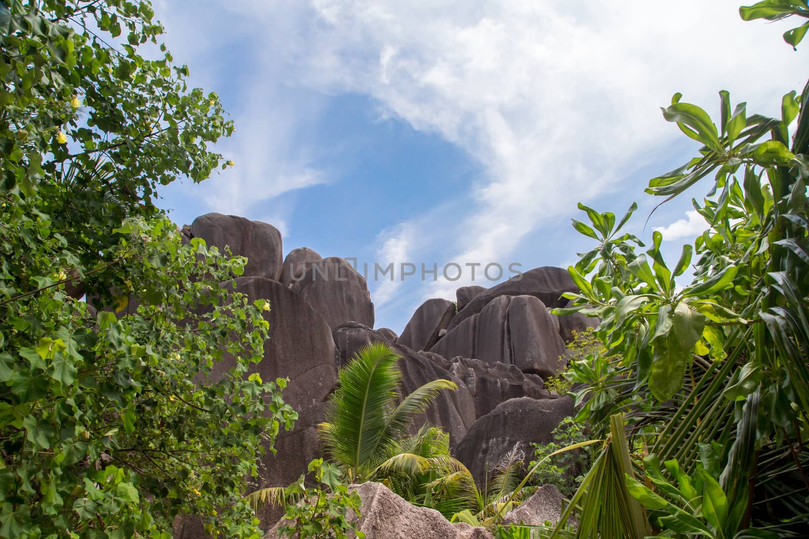 Blue sky with some clouds and big stones in front
