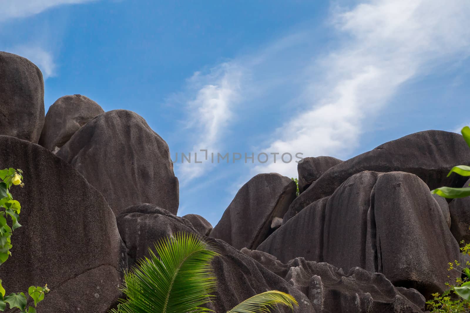 Blue sky with some clouds and big stones in front