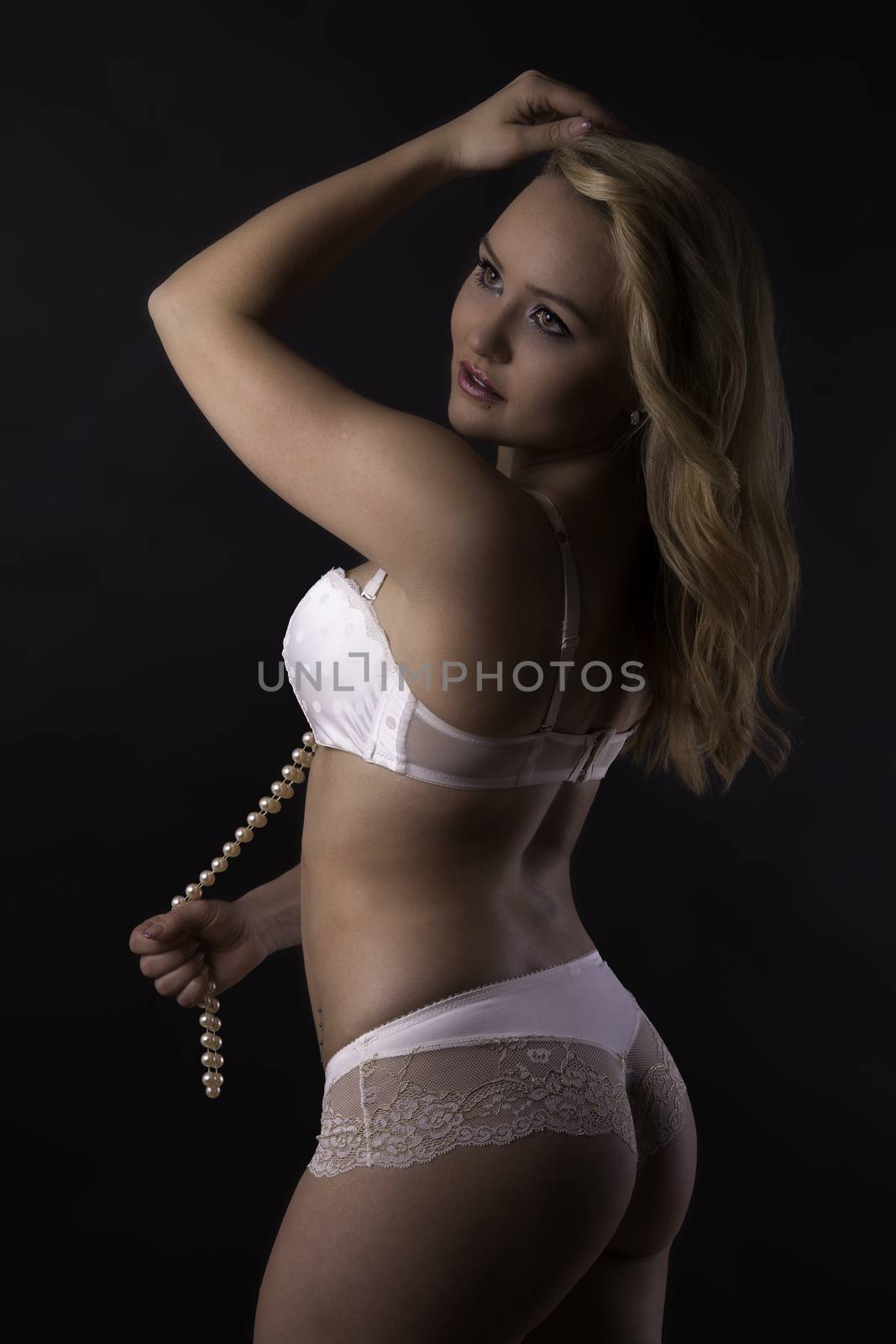sexy attractive young blonde woman in white dessous