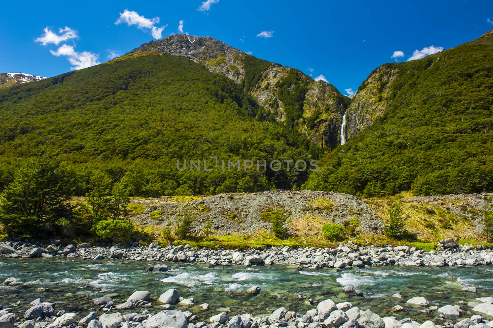 Bealey River in front and Devil's Punchbowl Waterfall in the back could be found in the Arthur's Pass National Park, New Zealand