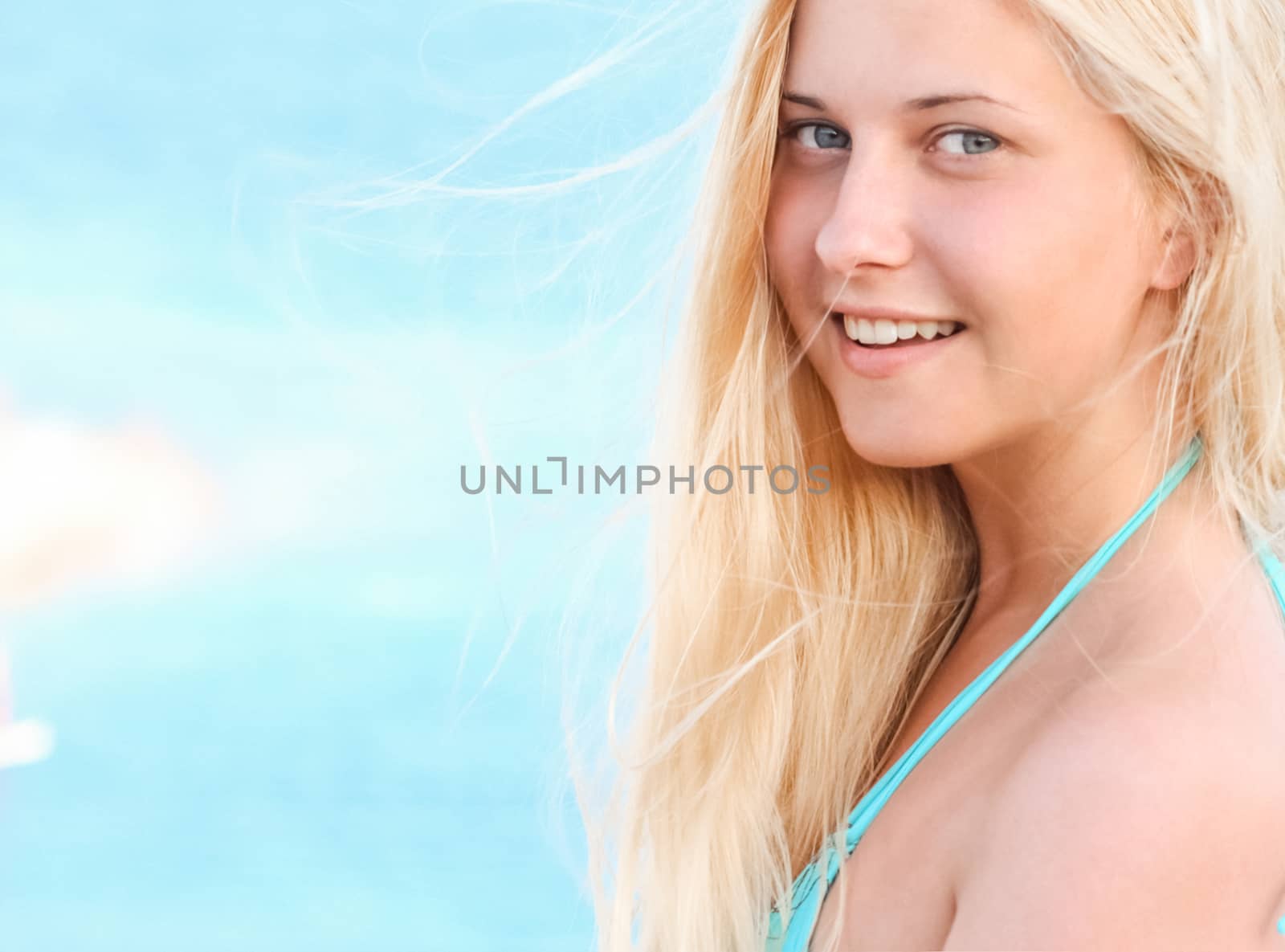 Woman with blond hair enjoying seaside and beach lifestyle in summertime, holiday travel and leisure concept